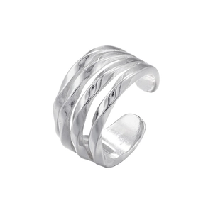 Macro shot of silver irregular fluid lines and metallic texture on a minimalist open ring