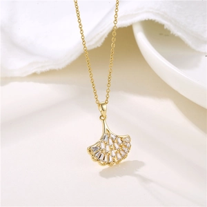 Elegant gold ginkgo leaf pendant necklace with micro-pave zircons on a classic O-chain