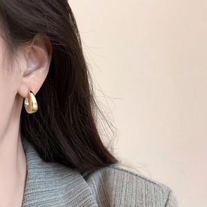 French style gold thick curved drop earrings with a polished mirror finish for women