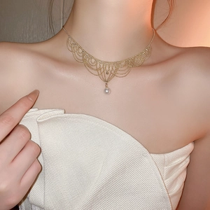 Close-up of 24K gold-plated lace choker with 12mm pearl and vintage mesh detailing