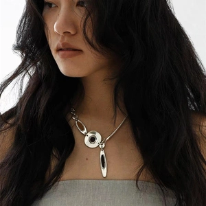 Minimalist silver irregular geometric necklace with dark enamel inlay on female model