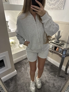 Mirror selfie showing fit of gray long sleeve zipper hoodie and matching shorts set