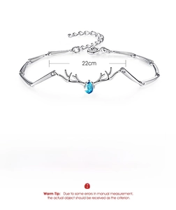 Macro detail of silver deer antler bracelet with blue teardrop zircon and size specs