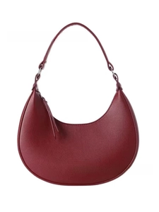Detailed view of the dark red crescent moon shoulder bag with metallic zipper closure