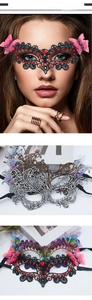 Detail of lace butterfly masquerade mask with vibrant rhinestones and elegant ribbons