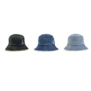 Three colors of distressed denim bucket hats with frayed edges for street style fashion