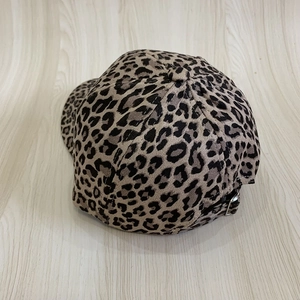 Détail d'une casquette léopard avec boucle métallique réglable à l'arrière du chapeau