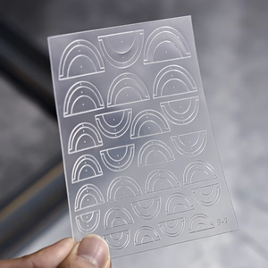 Macro detail of F-9 nail art stencil template with rainbow and arc patterns