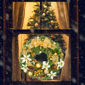 Detailed Christmas wreath with gold ribbons, pine cones, and white flowers on a snowy window