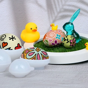 DIY Easter egg resin molds set with rabbit decor and decorative painted eggs on a grass tray