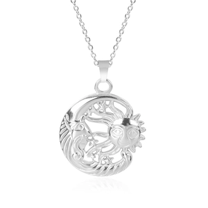 Macro detail of silver sun and moon pendant with hollowed celestial star patterns
