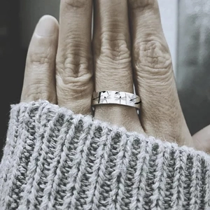 Silver dragonfly ring engraved with Appreciate The Little Things worn by a model