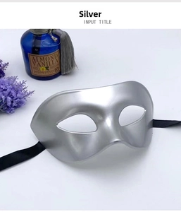 Detail of a silver Venetian half-face mask with matte finish and black silk ties