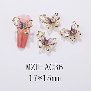 Macro detail of purple iridescent butterfly nail charm with gold frame and pearls