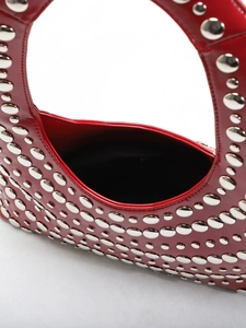 Angola red studded punk U-shaped underarm bag in glossy patent leather finish