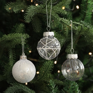 6cm Christmas ball set with glitter patterns hanging on a tree with bokeh lights