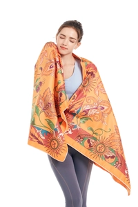Detail view of double-sided microfiber beach towel with vintage sun and floral patterns
