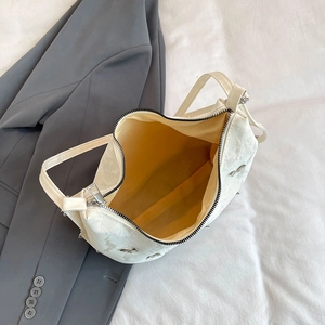 Large cream white pleated crossbody bag with yellow lining and silver metal zipper