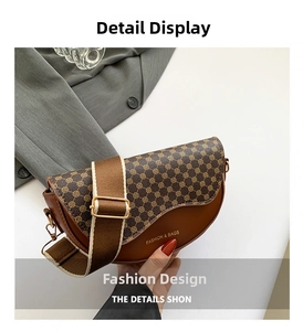 Detail of vintage saddle bag with brown monogram leather and wide fabric shoulder strap