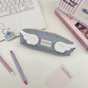 Close-up of blue canvas pencil case featuring white plush wings and silver star patterns