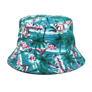 Close-up of tropical flamingo and palm tree prints on a blue bucket hat detail