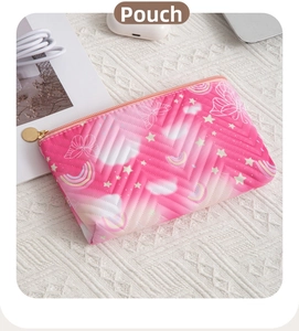 Detail of pink gradient cosmetic bag with quilted texture and cute rainbow pattern
