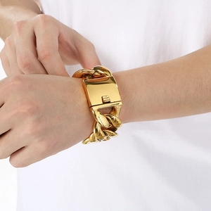 Close-up of 30mm wide golden stainless steel Cuban link bracelet with box clasp on wrist