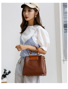 Fashionable woven texture caramel tote bag with golden hardware shown in a lifestyle shot