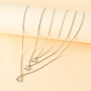 Detailed view of three silver stainless steel necklaces with horse and heart pendants