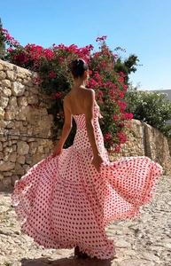 Close-up of white and red polka dot bandeau dress with voluminous layered ruffles
