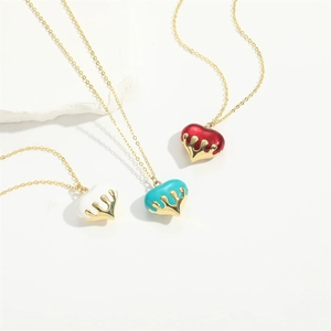 Three gold heart pendant necklaces in white, red and blue with a sleek metallic finish