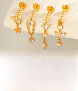 Detailed macro view of F136 titanium gold labret stud with zircon chain dangles