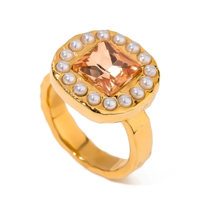 Vintage 18k gold plated ring with champagne gemstone and pearl halo on white background