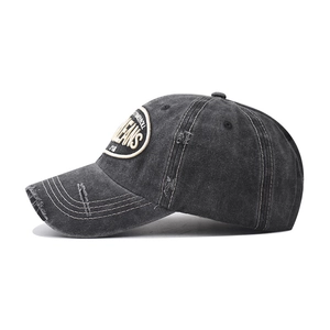 Detailed close-up of distressed vintage cotton baseball cap with JEANS embroidery patch