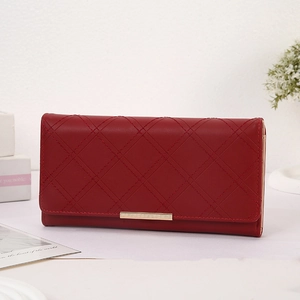 Close-up of deep red quilted long wallet with elegant gold metal trim on the flap