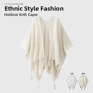 Detailed view of the hollow-out knit texture and long tassels on this ethnic cape