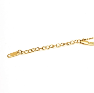 Macro detail of 18K gold plated titanium blade chain with extender link and clasp