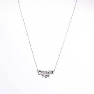 Detail of silver Angelina name necklace with a gothic font and spider pendant