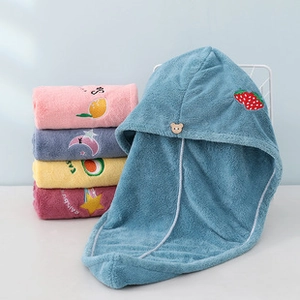 Detail of coral fleece hair towel wrap showing absorbent fabric and cute embroidery