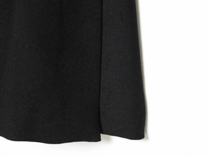 Macro view of black twill fabric showing detailed texture and precision stitching
