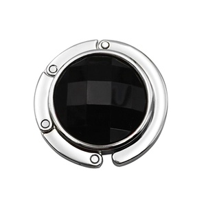 Polished silver handbag hook with a faceted black gemstone inlay for desk use
