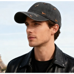 Detail of dark grey washed baseball cap featuring colorful dachshund dog embroidery patterns