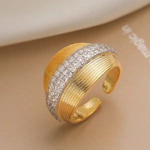 Macro detail of gold plated wide band ring with vertical stripes and zircon inlay