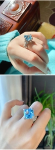 Macro detail of Asscher cut aquamarine ring with diamond-encrusted twisted silver band