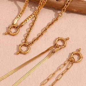 Macro view of gold plated stainless steel snake, link, and cable chains with lobster clasps