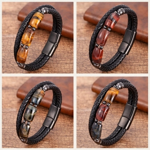 Detail view of woven leather bracelets with tiger eye stones and magnetic clasps