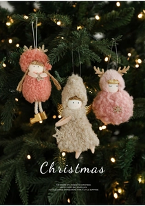 Close-up of plush Christmas deer and angel dolls with sequins on a decorated Xmas tree