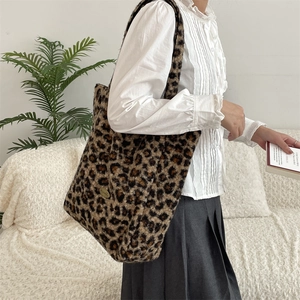 Close-up of leopard print plush tote bag featuring soft faux fur texture and metal plate