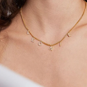 Golden stainless steel necklace with Leonie name pendant and zircon inlay worn by model