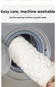 Detail of white memory foam bath mat being washed in a machine on gentle cycle